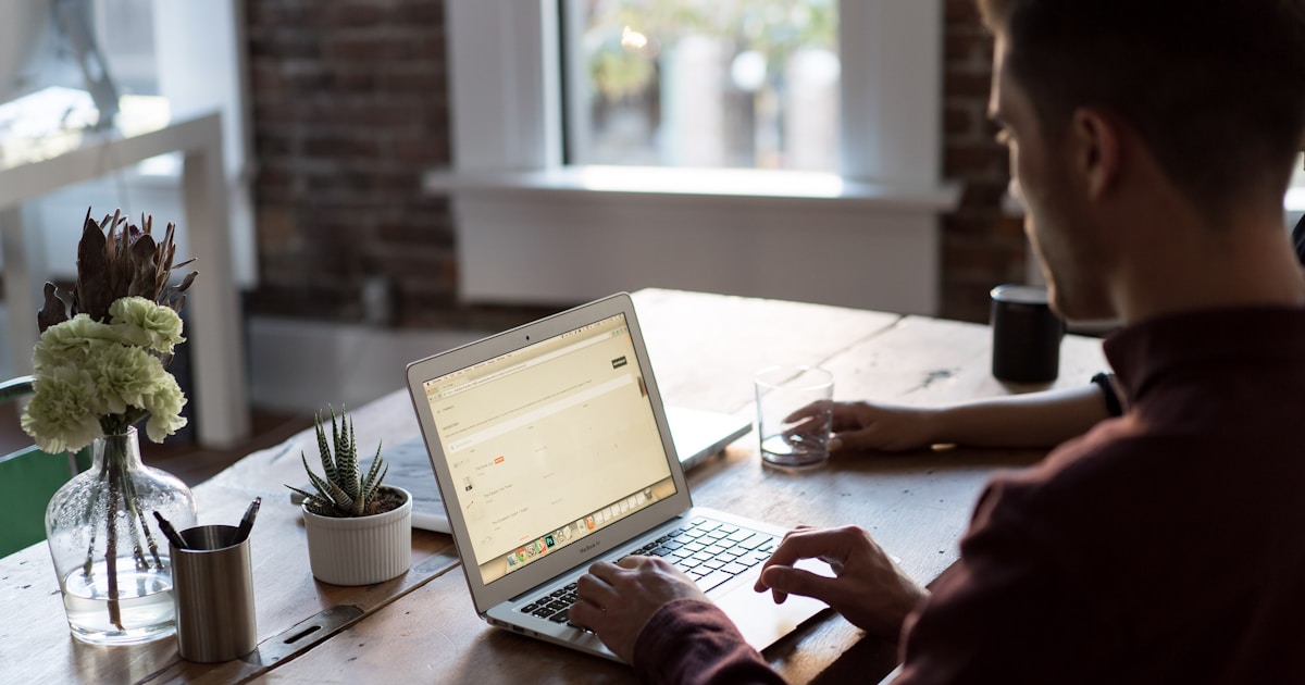 Online store owner working on a laptop at a desk