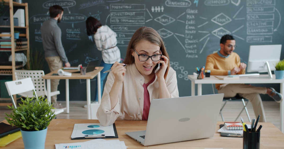 A woman celebrating success during a business call