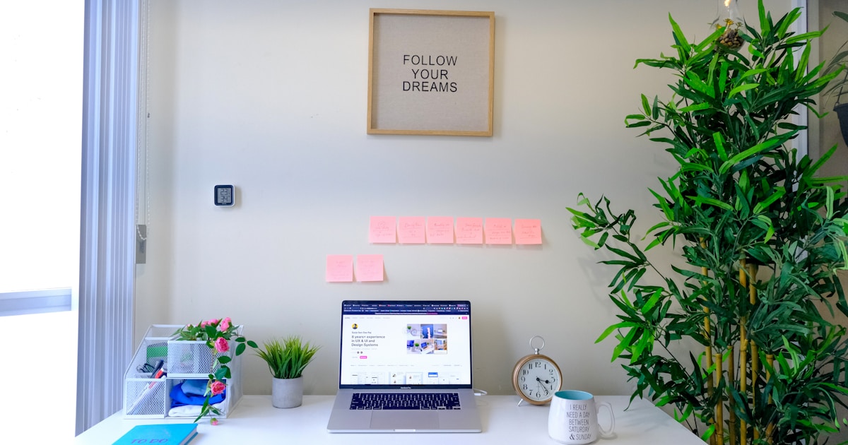 A tidy laptop workspace on a white desk