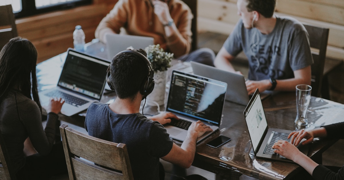 A team working together around laptops