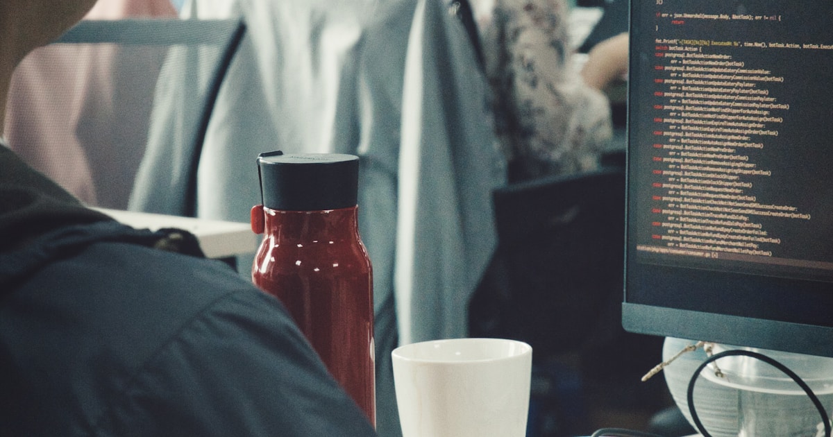 A man working at a desk with a monitor