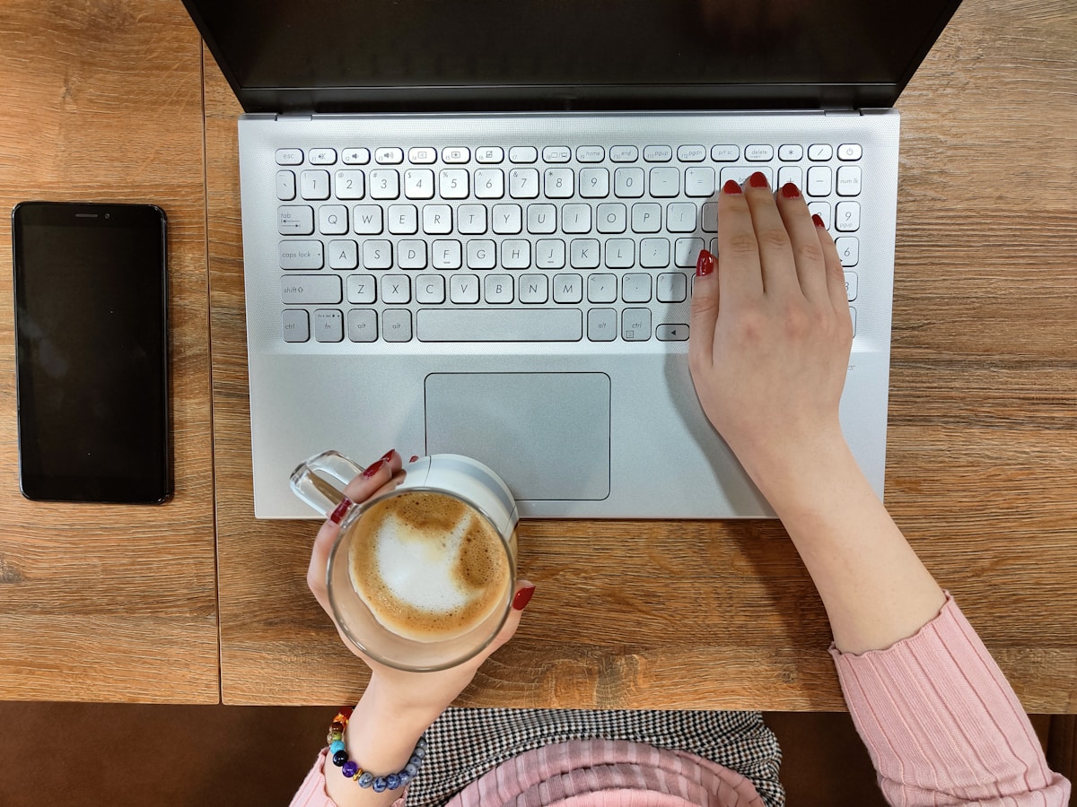 Hands typing on a laptop keyboard
