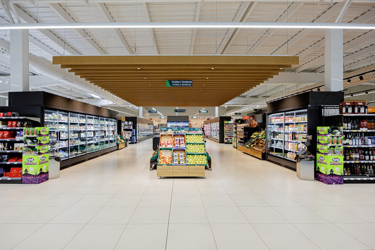 A brightly lit retail aisle stocked with products