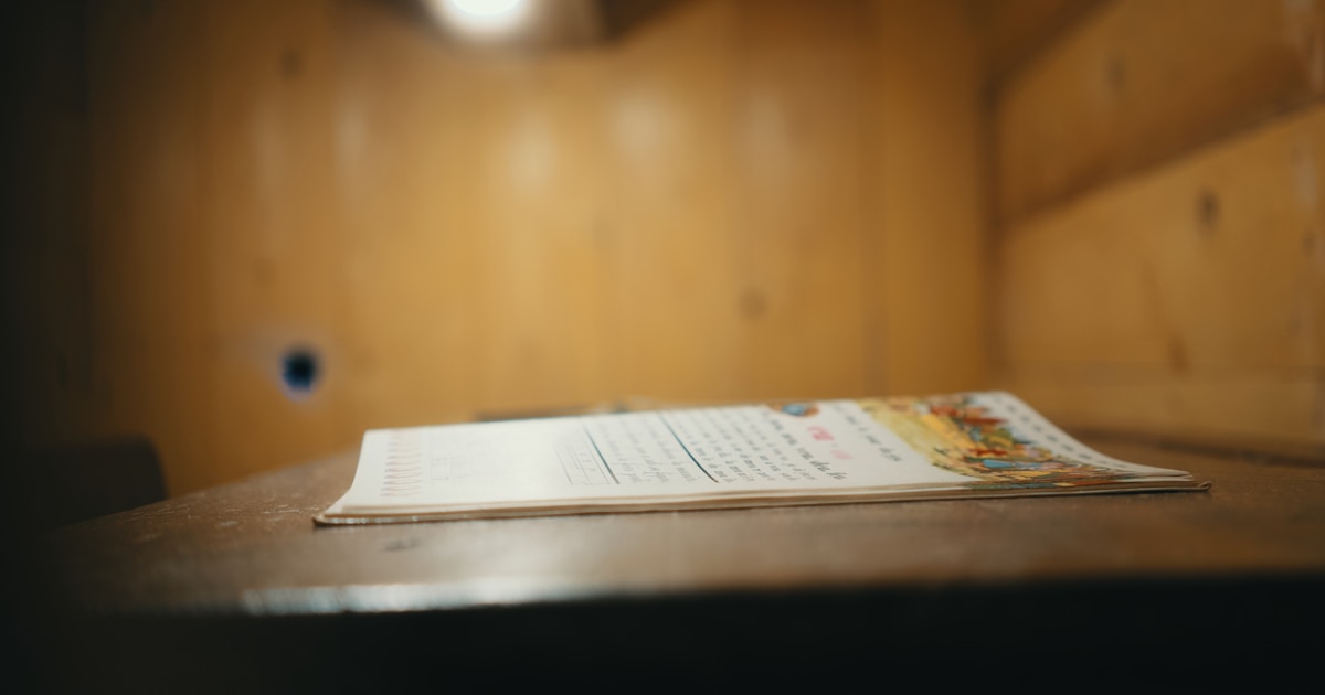 A document lies on a wooden table